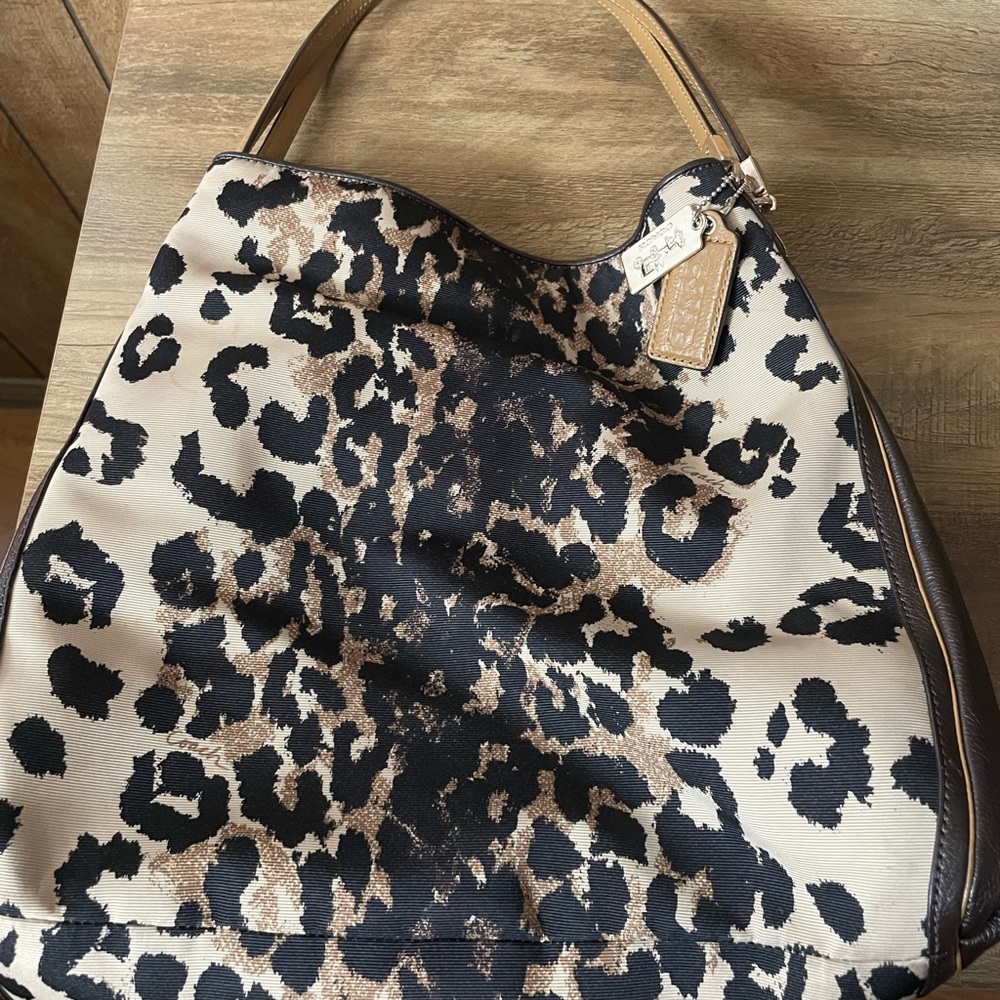 Madison coach bag good condition has one small little rip on the strap, clean.